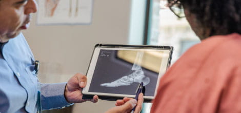 Doctor explaining the findings of an x-ray to his patient